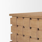 Close-up side detail of the Varelle Coffee Table showing the sculpted woven mango wood pattern beneath the top.