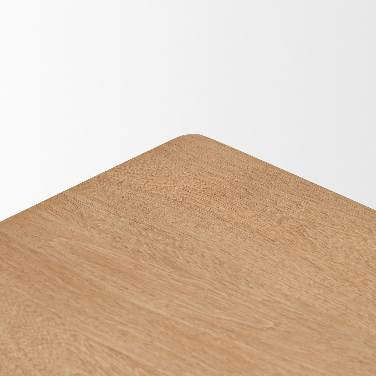 Close-up corner detail of the Varelle Side Table showing the solid mango wood top above the carved woven base.