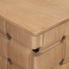 Close-up side detail of the Varelle Side Table highlighting the carved woven mango wood pattern beneath the top.