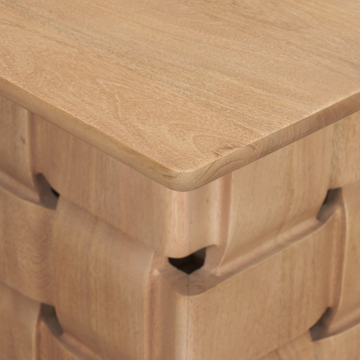 Close-up side detail of the Varelle Side Table highlighting the carved woven mango wood pattern beneath the top.