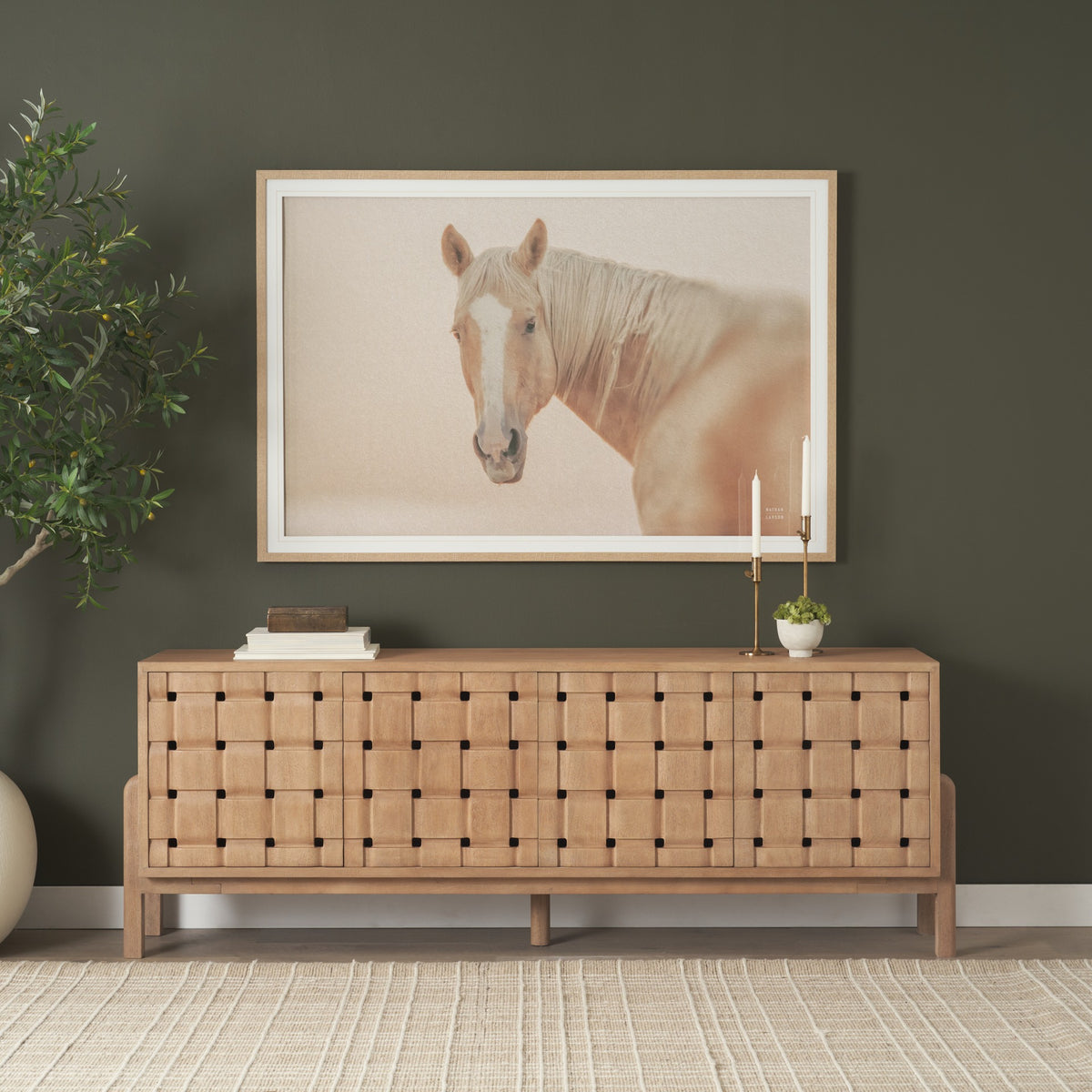 Varelle Carved Mango Wood Sideboard styled in a warm contemporary room beneath framed horse artwork.