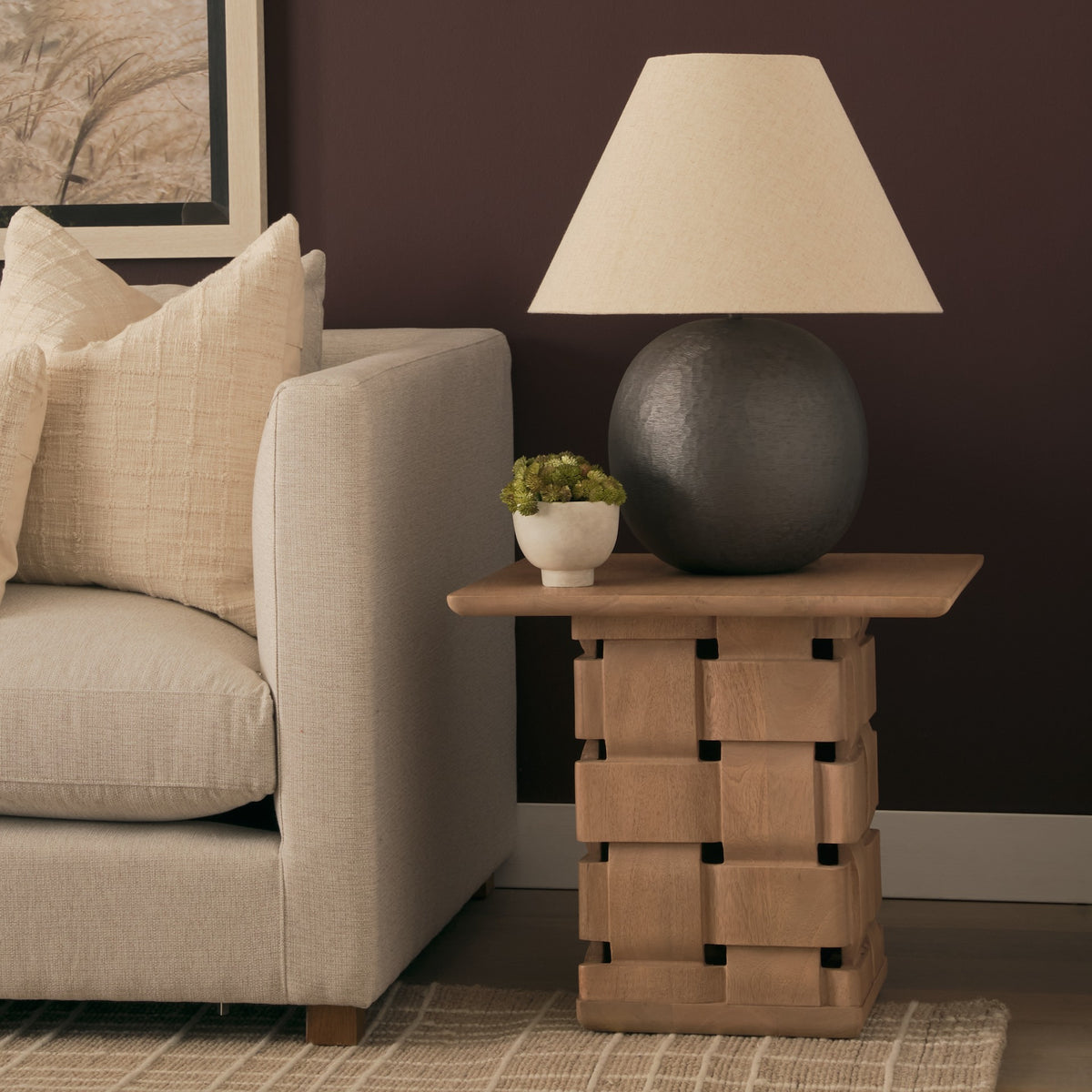 Varelle Carved Mango Wood Square Side Table styled beside a neutral sofa with a table lamp and small planter.