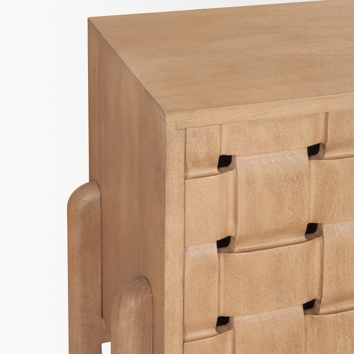 Close-up of the Varelle Sideboard carved woven door pattern and rounded side support at the cabinet corner.