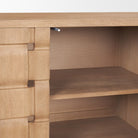 Interior detail of the Varelle Sideboard showing the wood cabinet compartment and removable shelf storage.