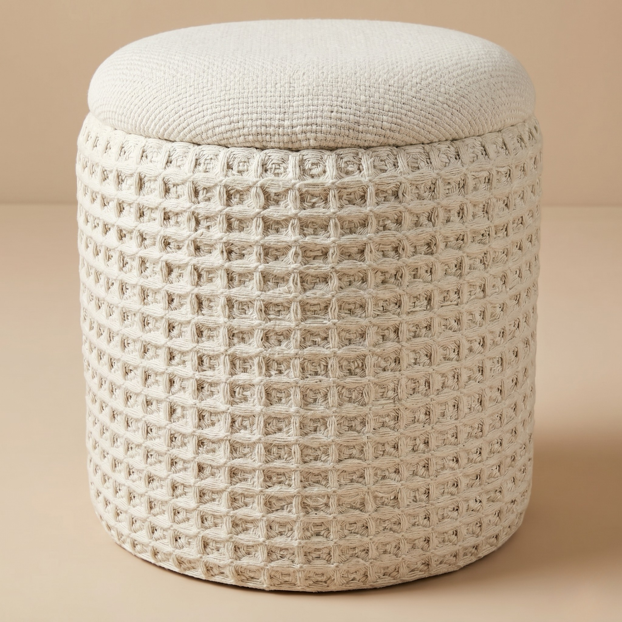 Textured round ottoman on a beige background