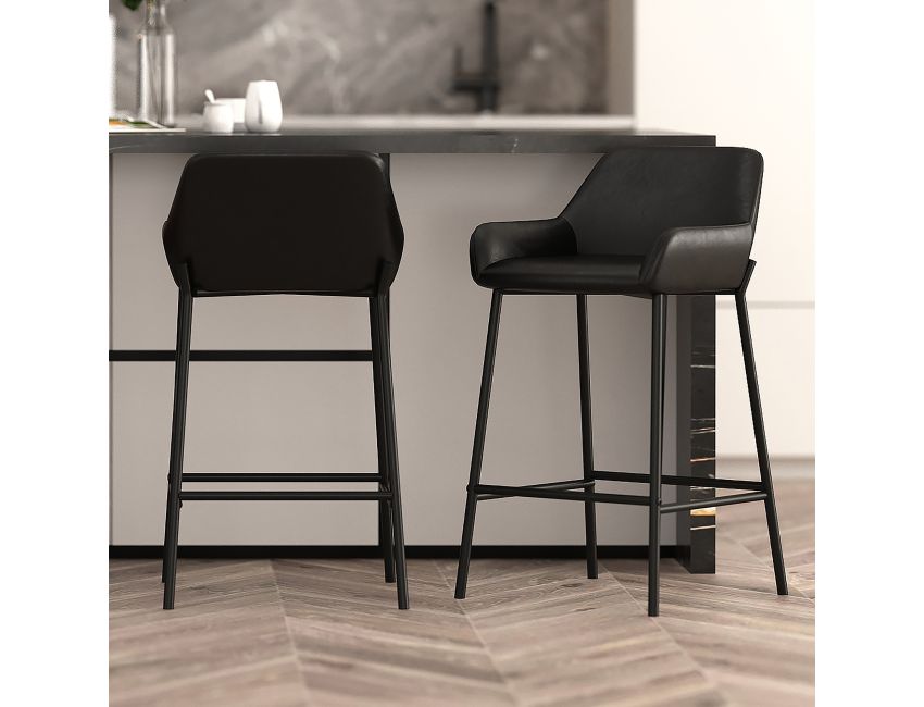 Two black bar stools in a modern kitchen setting.