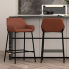 Two brown bar stools with black legs in a kitchen setting.
