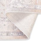 Folded corner of the Verona vintage-style area rug showcasing its soft, low pile face and durable woven underside backing.