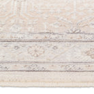 Macro close-up of the short, textured fringe and faded traditional oriental pattern on the edge of the Verona area rug.