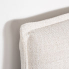 Macro close-up view highlighting the textured cream linen-blend fabric and the precise stitching of the French seam.