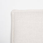 Close-up of the Vivienne bed headboard corner showcasing the high-quality French seam flange upholstery detail.