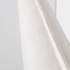 Angled macro shot of the Vivienne bed's headboard showcasing the clean lines of the flanged edge and the soft fabric weave.