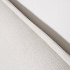 Detailed profile shot of the Vivienne bed headboard edge emphasizing the architectural flange seam tailoring.