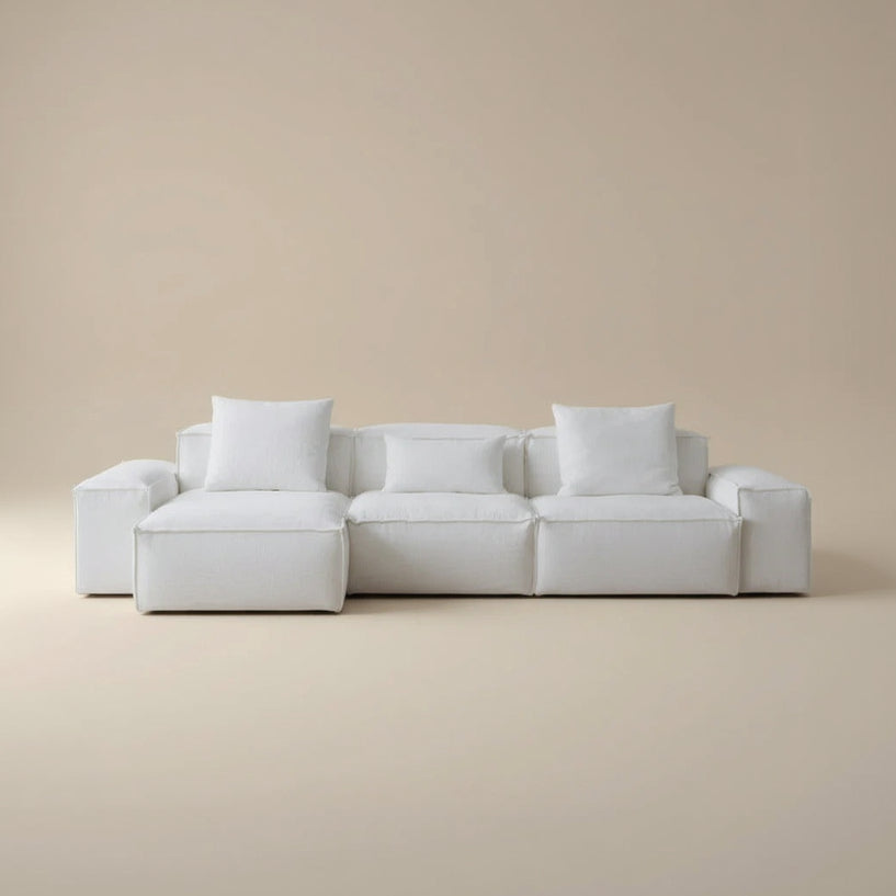 White sofa with cushions on a beige background