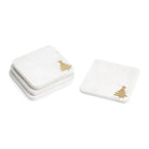 Set of four white marble square coasters with gold Christmas tree accents