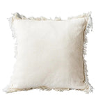 White pillow with frayed edges on a gray background