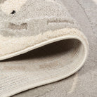Folded detail of the Zoomie Lane Kids Rug showing the bound edge and woven backing.