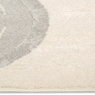 Close-up of the Zoomie Lane Kids Rug surface showing the soft ivory and grey pile texture.