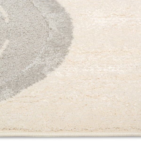 Close-up of the Zoomie Lane Kids Rug surface showing the soft ivory and grey pile texture.